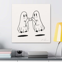 Minimalist ghost art print titled "Past Lives" featuring two ghosts playfully interacting, displayed on a modern desk.