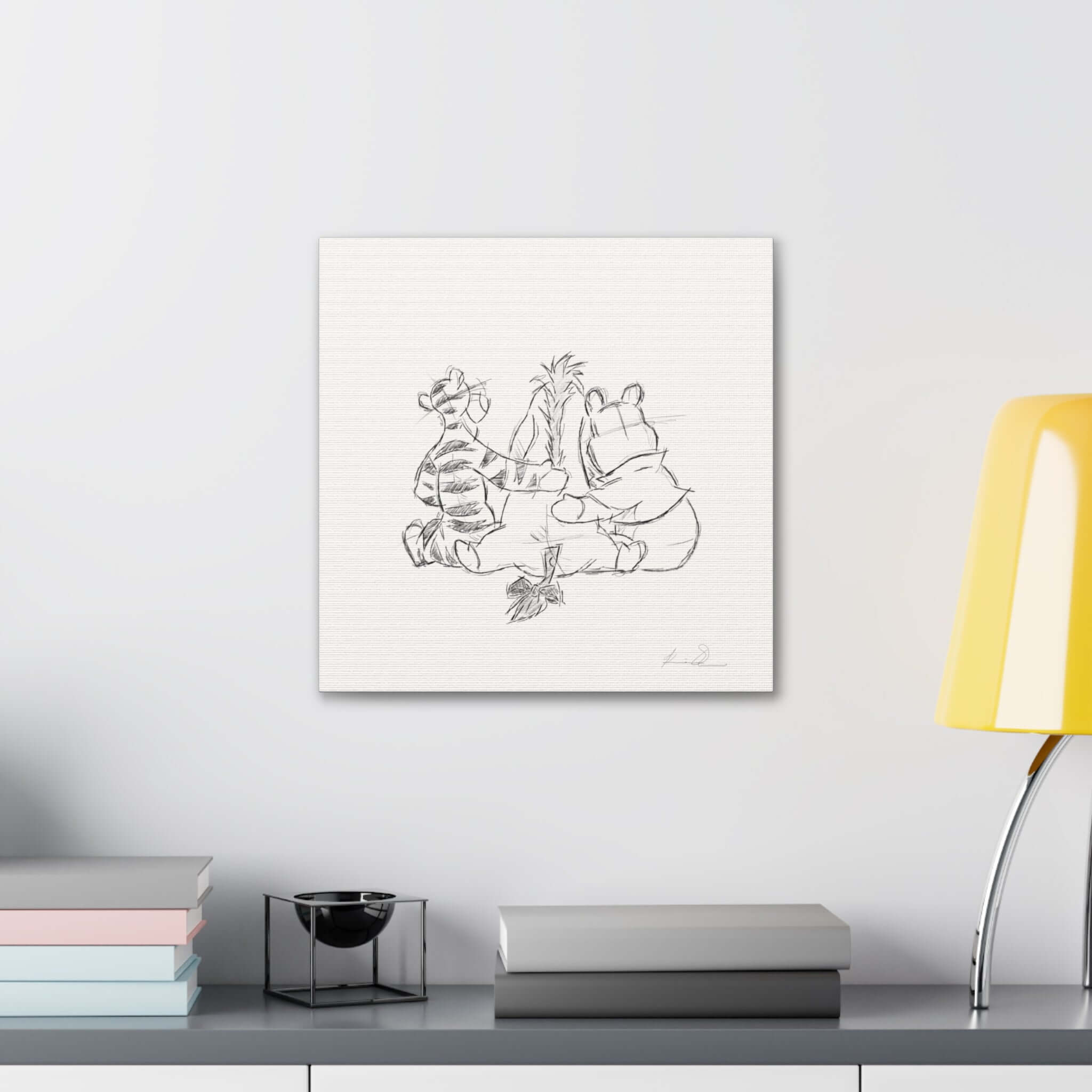 Sketch of two characters high-fiving, framed on a wall with a modern desk lamp and stacked books below.